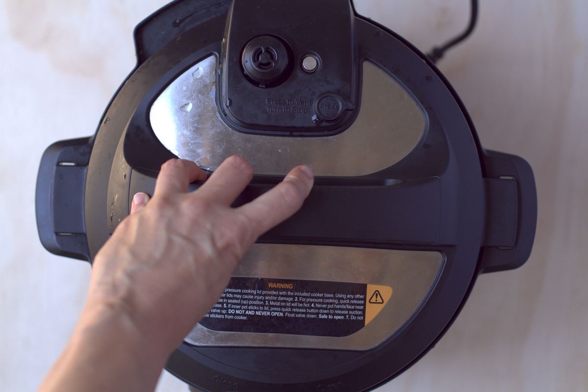hand on instant pot lid