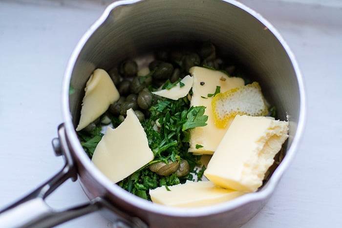 Making caper garlic butter sauce for the vegetables