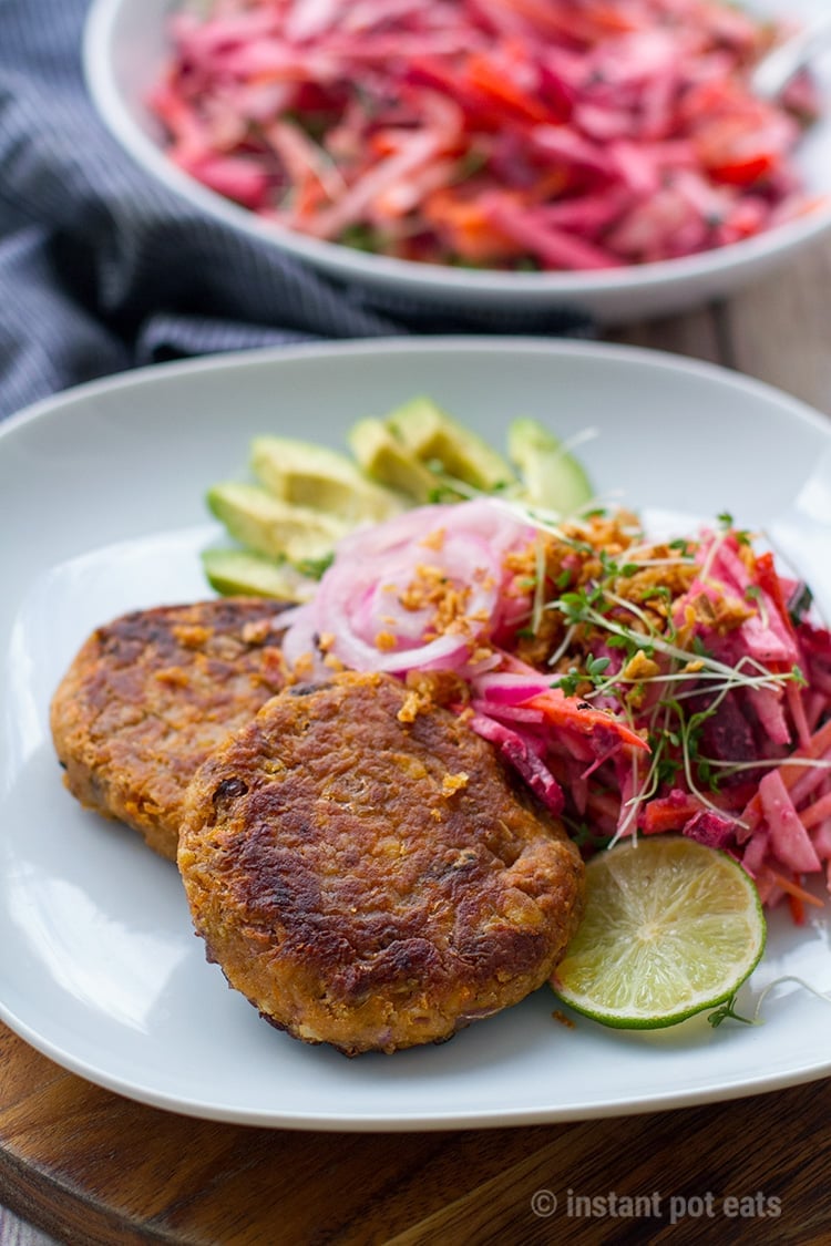 Vegan burgers with beet slaw, avocado and pickled onions