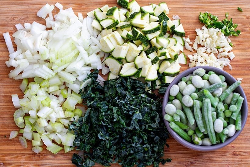 Vegan risotto ingredients: zucchini, kale, green beans, edamame, celery and onions