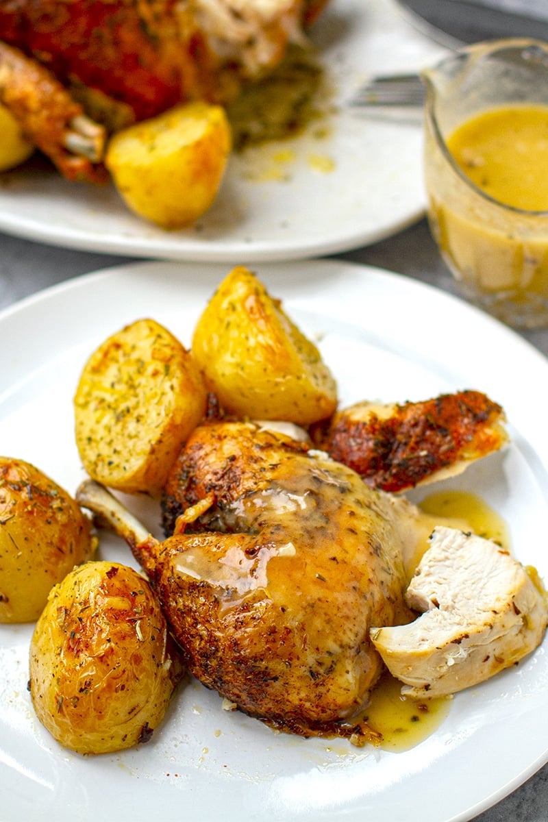 Roast chicken with gravy and potatoes on a plate