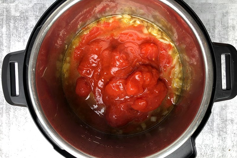 Add whole canned tomatoes to make tomato soup