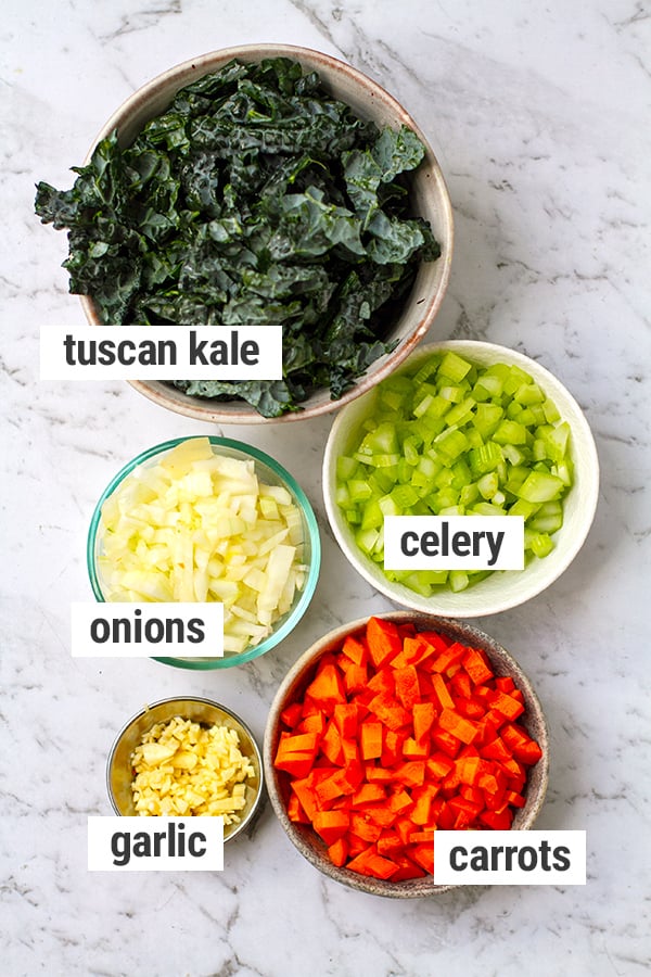 Vegetables used in pasta fagioli recipe: onions, garlic, carrots, celery and kale.
