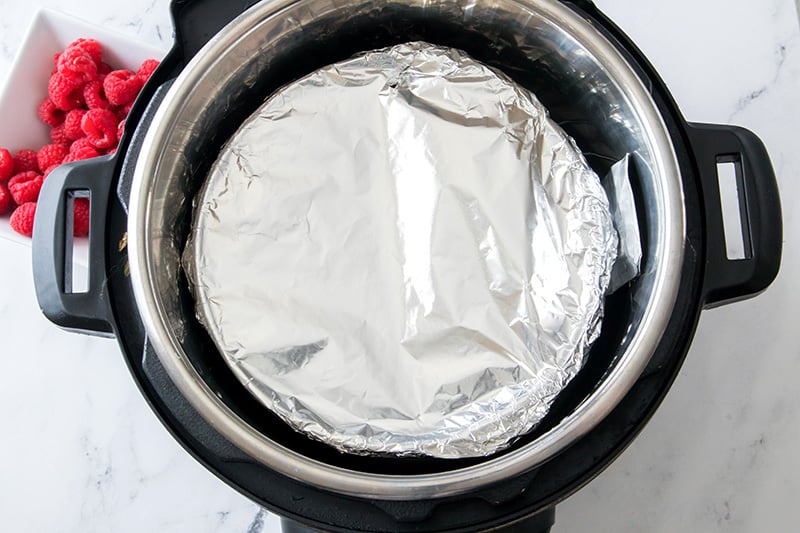 Cover cheesecake with foil and place inside the Instant Pot