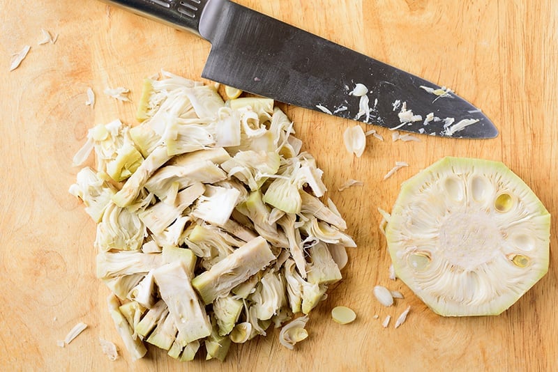 Young green jackfruit chopped on a board