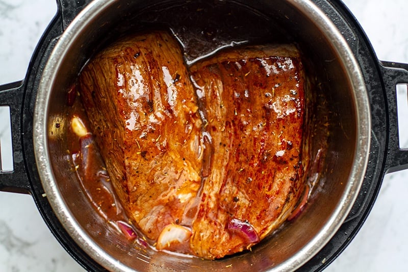How to make pot roast beef in the Instant Pot - place the meat in the broth