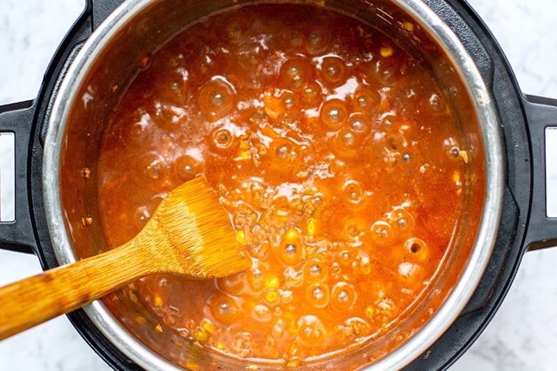 Simmering the filling mixture to reduce the sauce