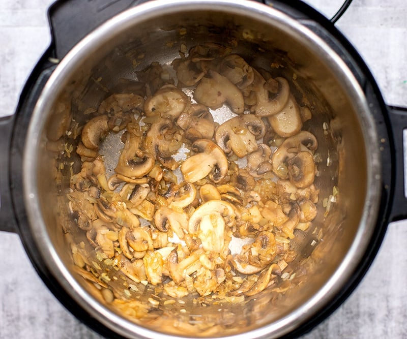 Cooking mushrooms and onions in the pot