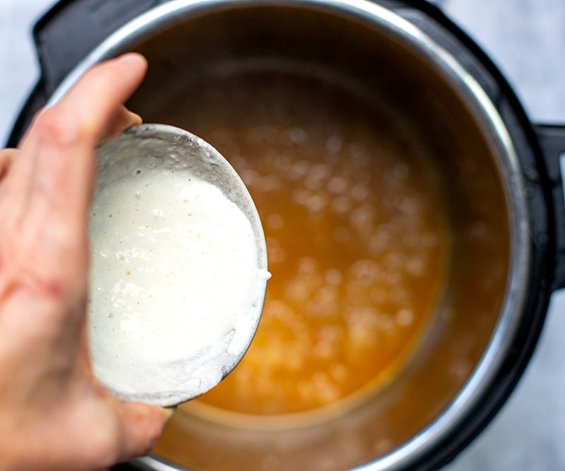 Add flour slurry to the pot to thicken sauce