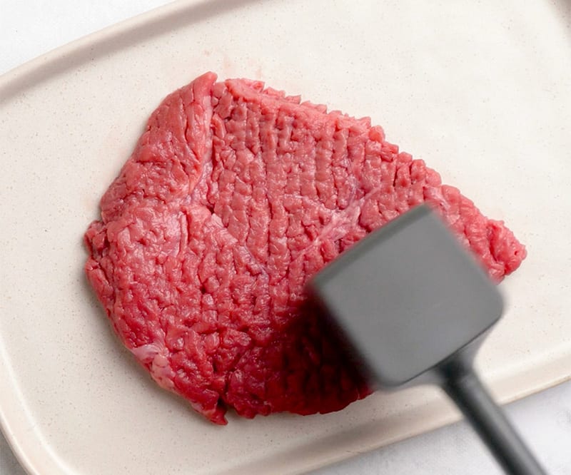 Tenderizing the steak with a mullet