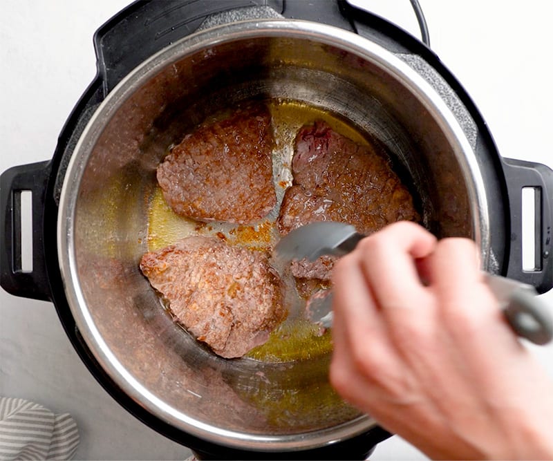 Searing steaks before cooking
