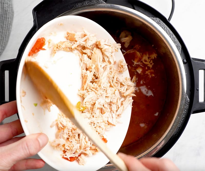 Add shredded chicken to the soup