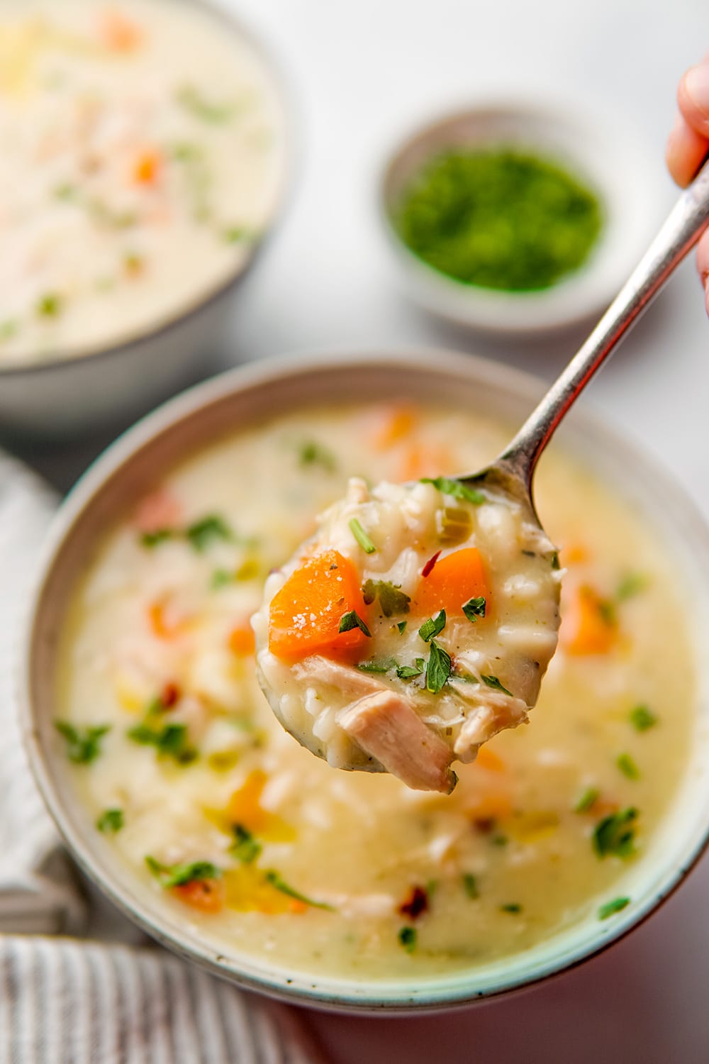 Instant Pot Lemon Chicken Orzo Soup in a bowl and in a spoon.