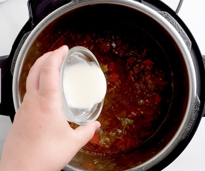 Stir in a tablespoon of flour mixed with 2-3 tablespoons of water to thicken it further.