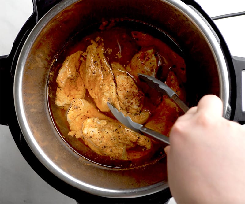 Remove the chicken from the Instant Pot and place it on a cutting board. Let it cool down. 