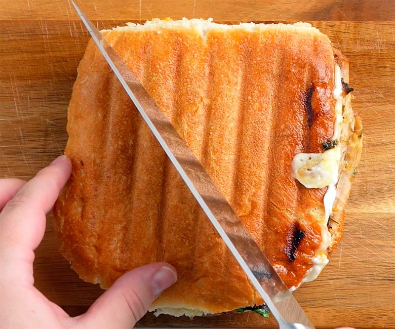 Cut the sandwich in half. - Instant Pot Mojo Pork & Cuban Sandwiches
