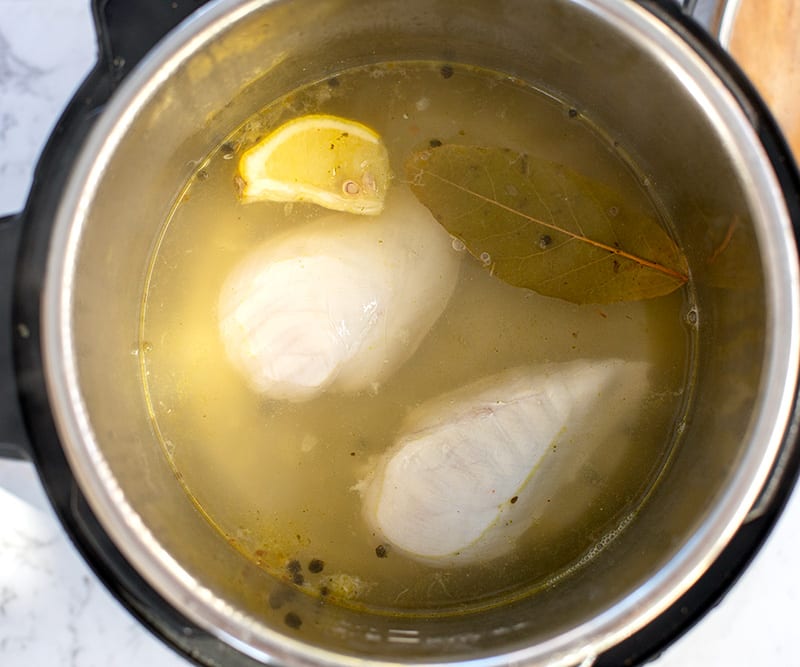 Nestle the chicken breasts in the hot flavored stock. Press the Keep Warm setting and cover the pot with a regular lid. Leave for 10 minutes, then turn the chicken breasts over and leave for 10 more minutes, about 20 minutes total (22-23 minutes for larger breasts or if using 3-4 breasts).