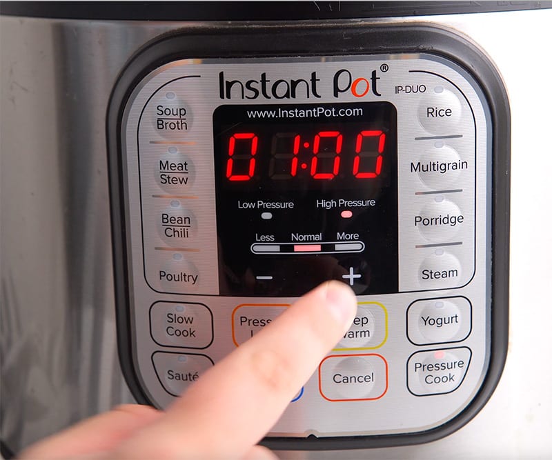 Close the Instant Pot lid and set the valve to the sealing position. Select the "Manual" or "Pressure Cook" button and set the timer for 60 minutes on high pressure. After the cooking cycle is complete, allow the Instant Pot to release pressure naturally for 10-15 minutes, then manually release the remaining pressure. - Instant Pot Mojo Pork & Cuban Sandwiches