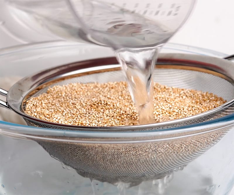 Rinse the quinoa under cold water and strain. This helps remove any residual bitterness or saponin.
