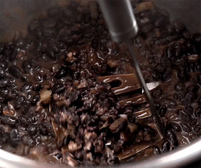 Mash and cook black beans