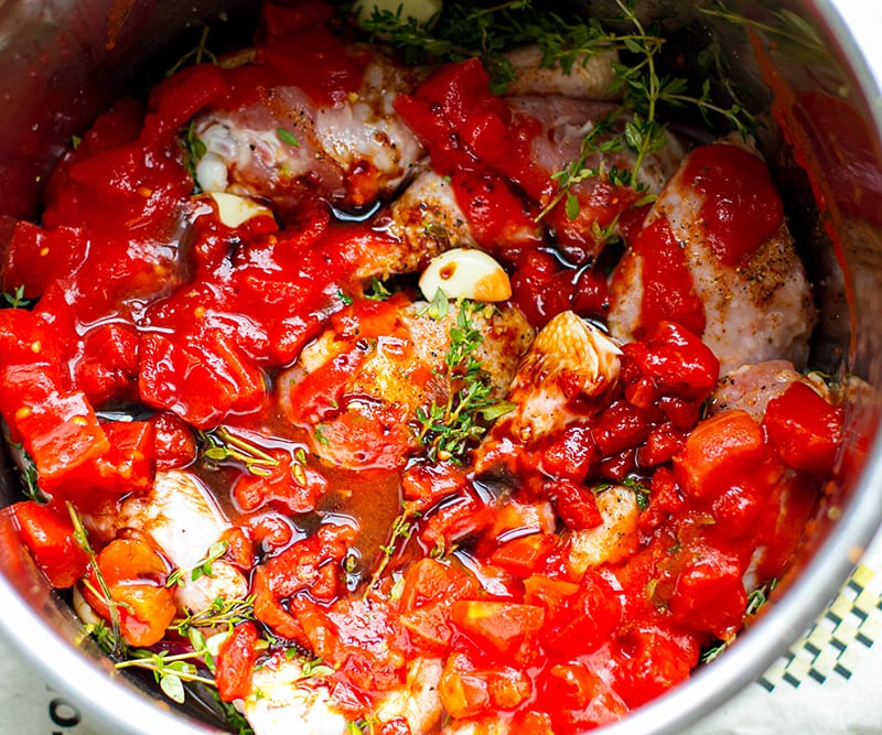 Tomatoes and balsamic on top of chicken in the pressure cooker