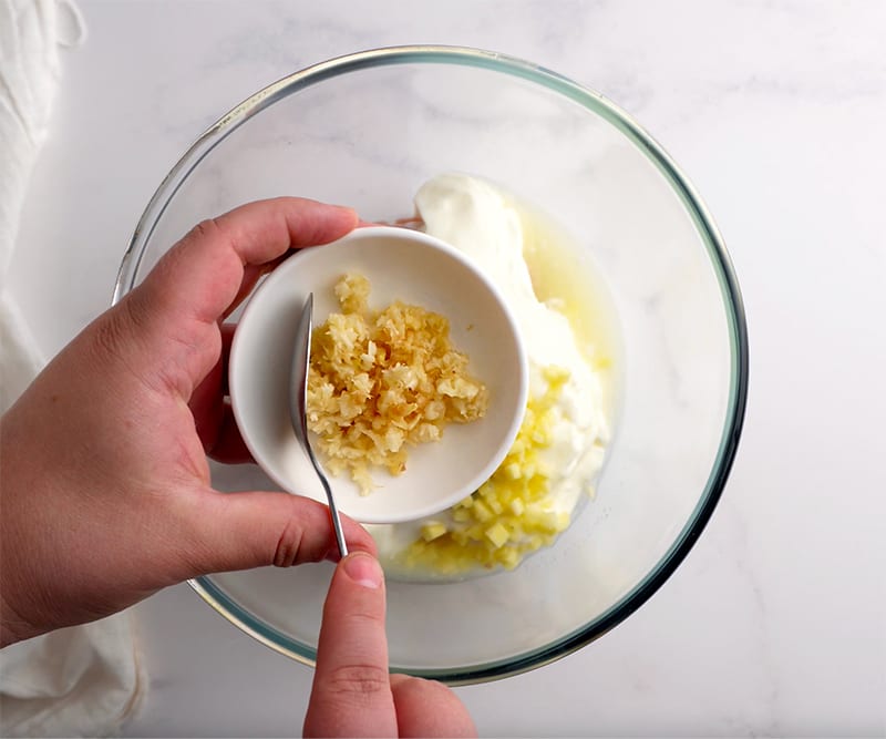 Mixing yoghurt garlic and ginger