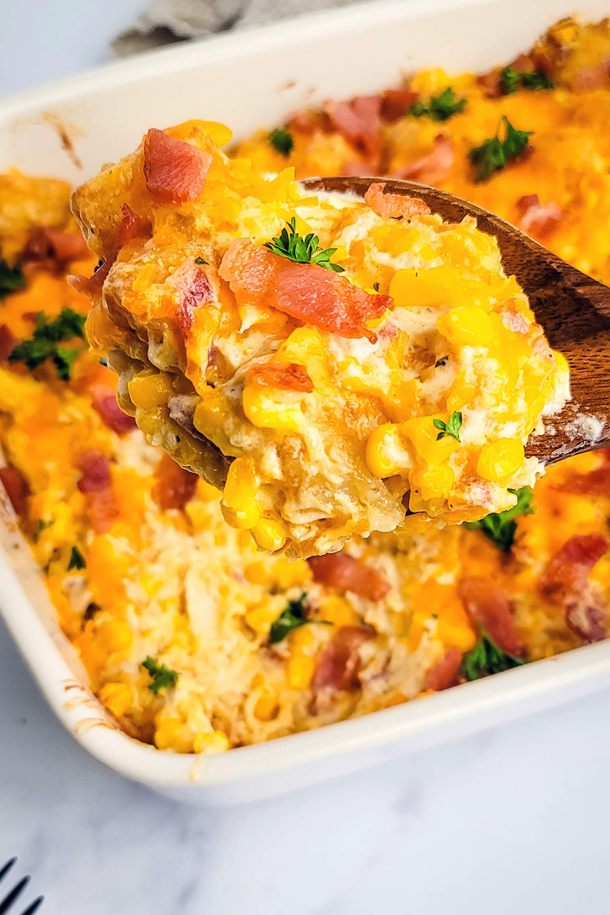 Chicken tater tot casserole with grilled cheese and crispy bacon in a baking dish