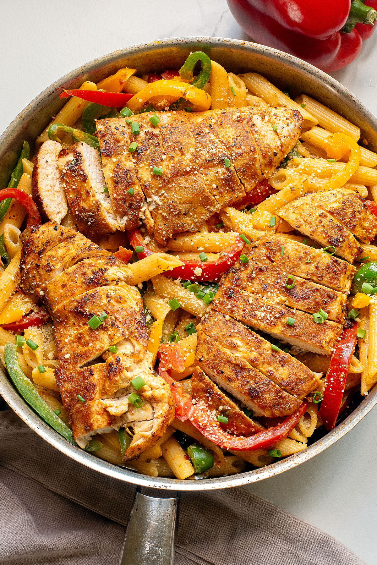 Jerk chicken pasta recipe (also known as rasta pasta with jerk seasoned chicken, bell peppers and creamy pasta in a skillet