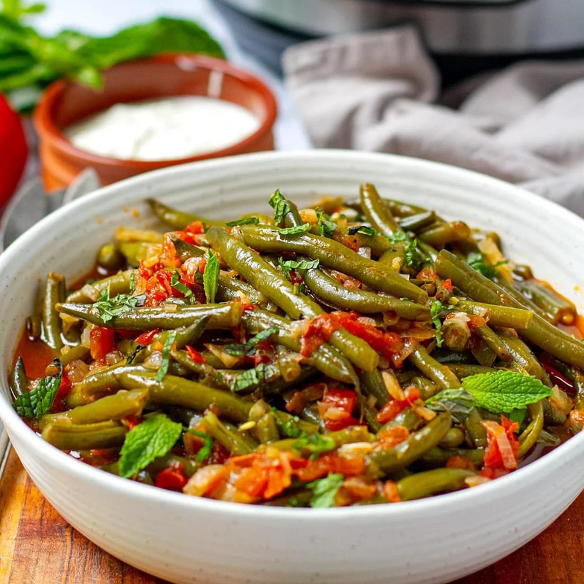 Tender Braised Green Beans with juicy tomatoes, simmered with garlic and herbs for a savory, comforting side dish that pairs well with any meal.
