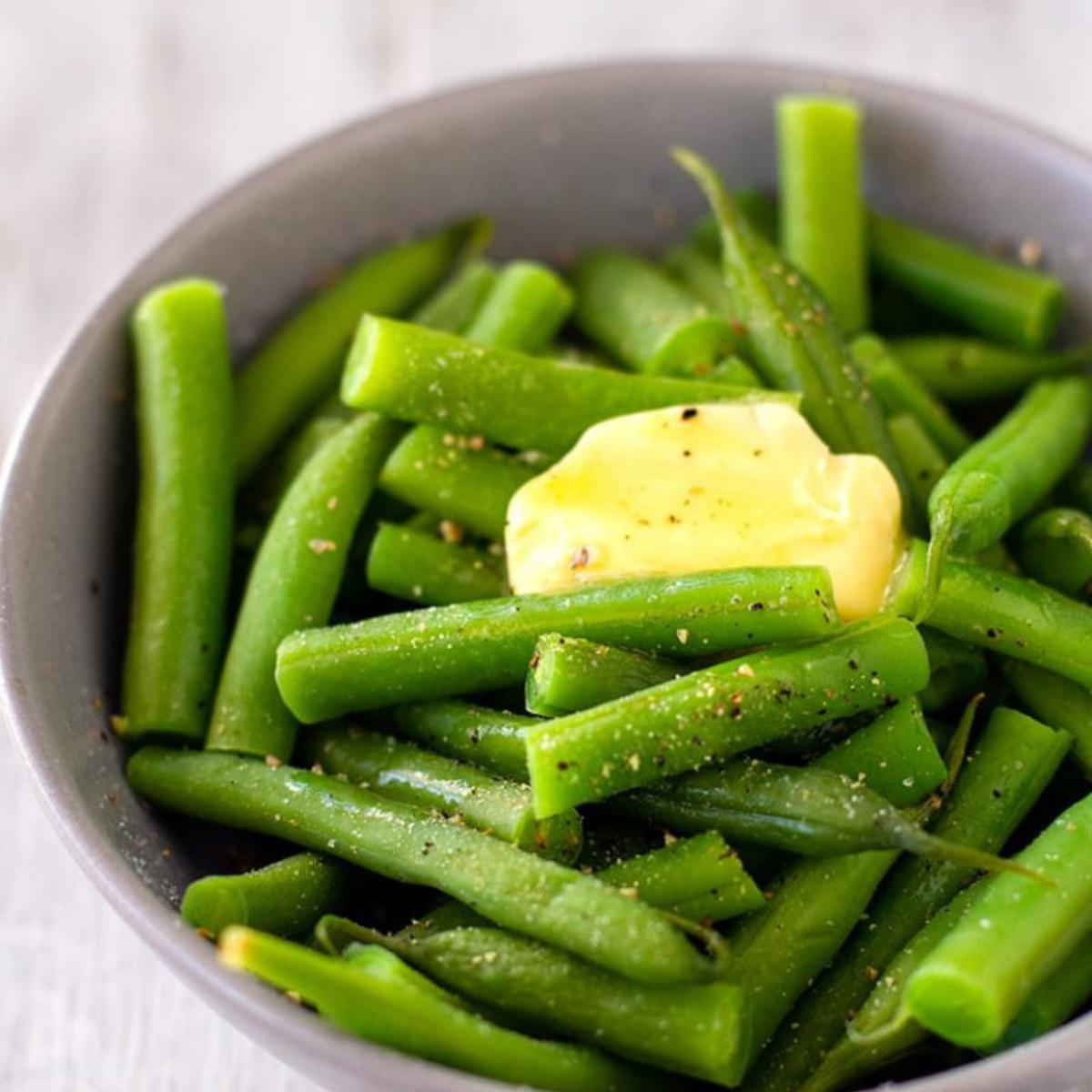 Tender Buttery Green Beans, sautéed in rich butter and seasoned with herbs, offering a simple yet flavorful side dish.