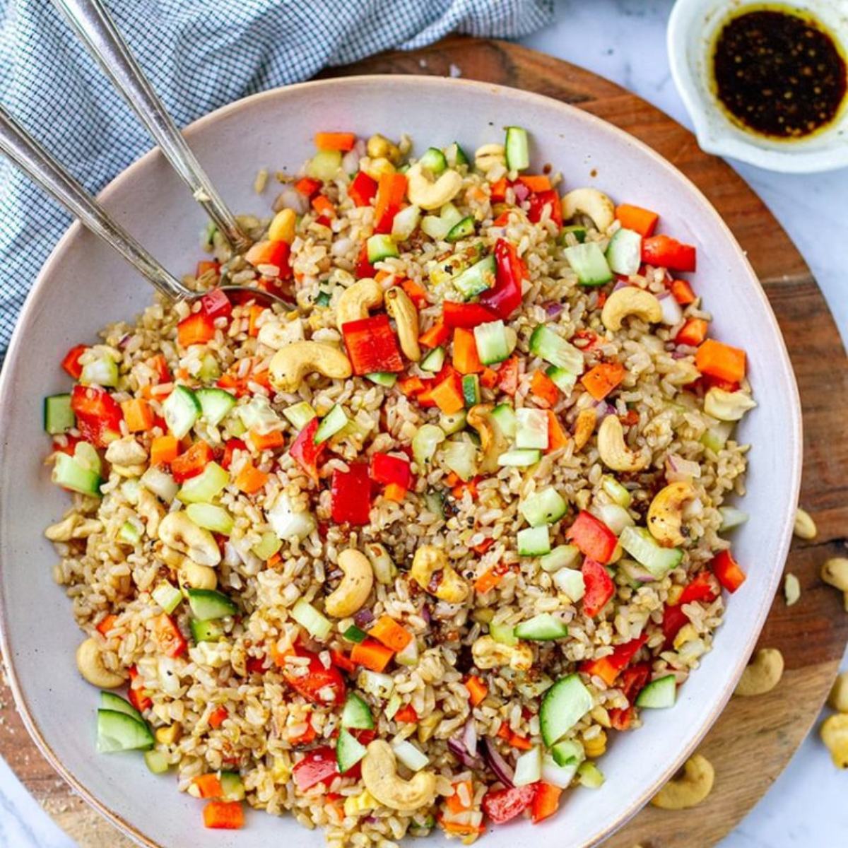 A vibrant Cashew & Brown Rice Salad with nutty brown rice, crunchy cashews, colorful veggies, and a tangy dressing, perfect for a healthy, filling meal.







