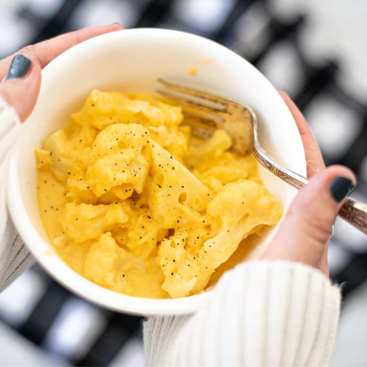 Creamy Cauliflower Mac and Cheese, with tender cauliflower florets smothered in a rich, cheesy sauce for a low-carb twist on the classic dish.







