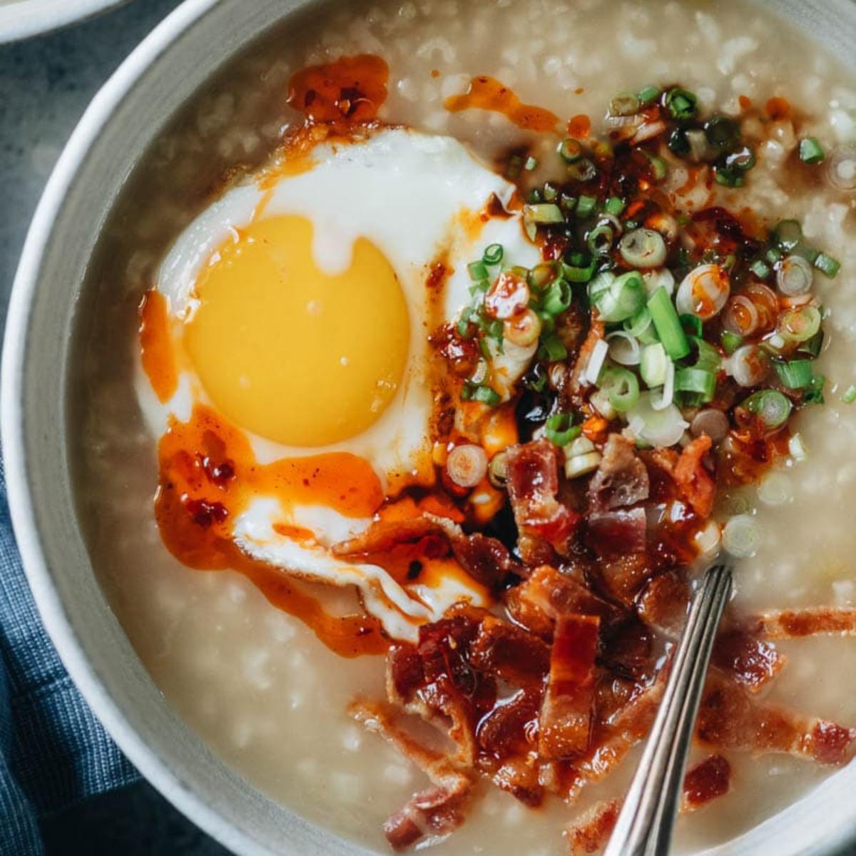 A comforting Instant Pot Breakfast Congee made with rice, warm spices, and a creamy broth, topped with your choice of sweet or savory toppings.








