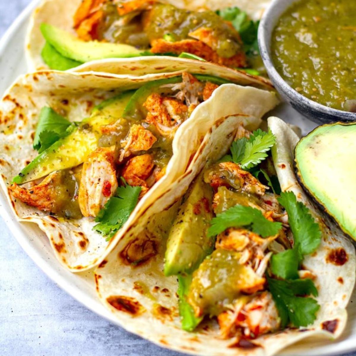 Flavorful Instant Pot Chicken Tacos with tender, shredded chicken in a spiced sauce, served in warm tortillas with fresh toppings like avocado, cilantro, and lime.