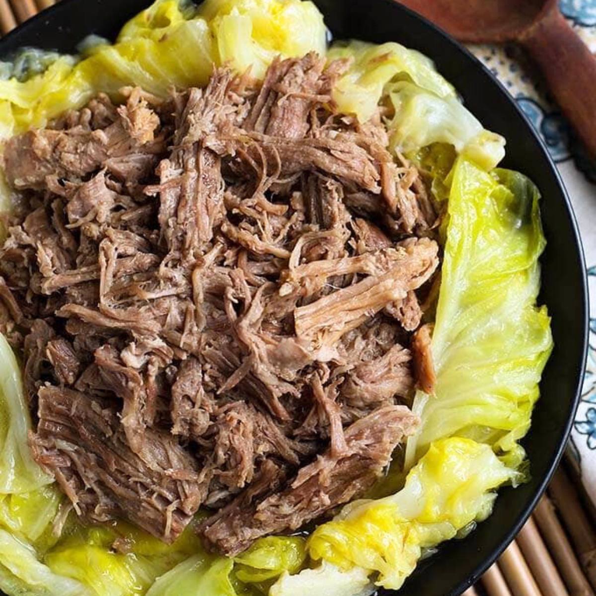 Tender Instant Pot Kalua Pork, slow-cooked with smoky flavors, shredded and served as a savory, melt-in-your-mouth dish.