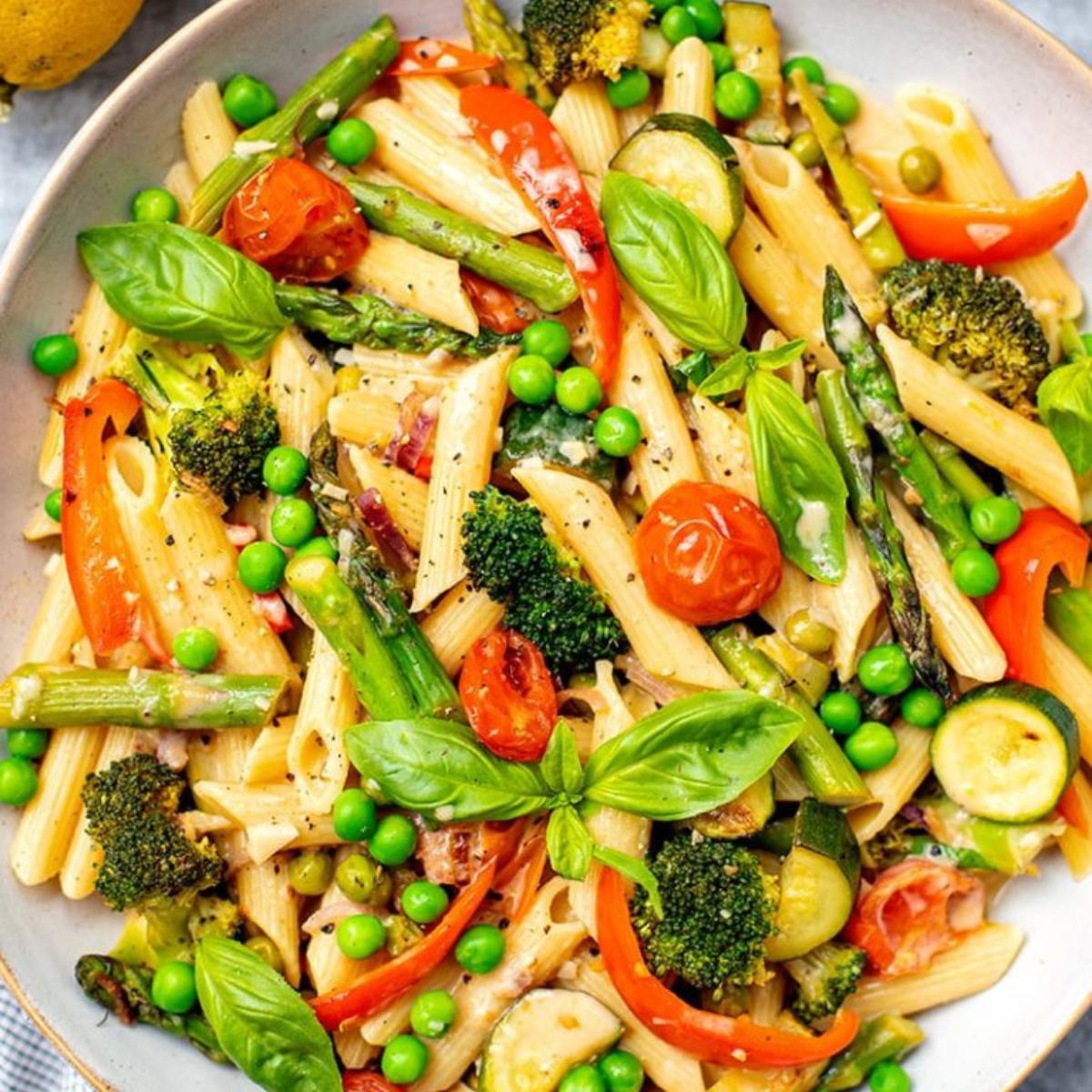 A vibrant Instant Pot Pasta Primavera with tender pasta, colorful vegetables, and a light garlic parmesan sauce, garnished with fresh basil.







