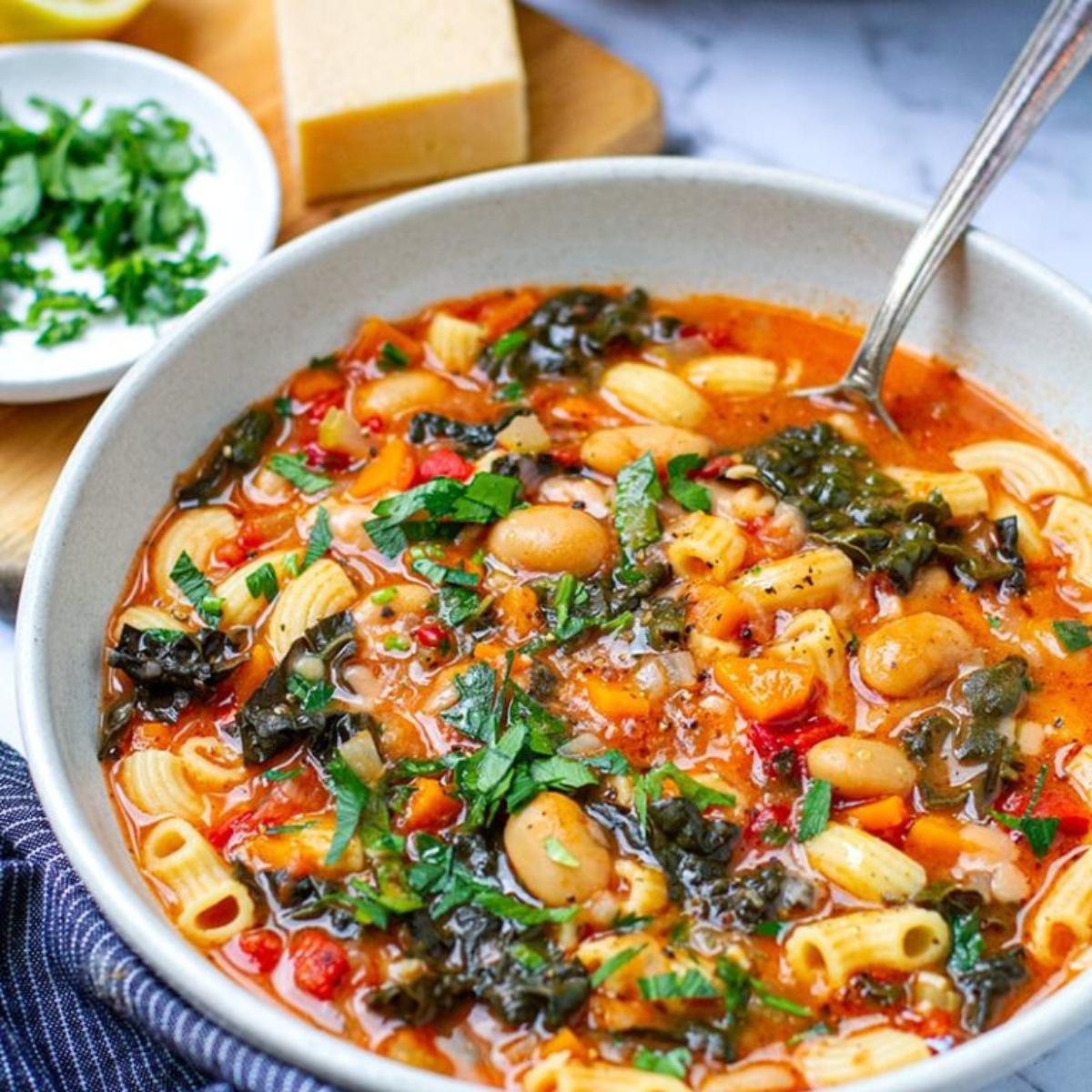 A comforting Instant Pot Pasta e Fagioli with tender pasta, beans, tomatoes, and vegetables, simmered in a savory broth and topped with grated Parmesan.







