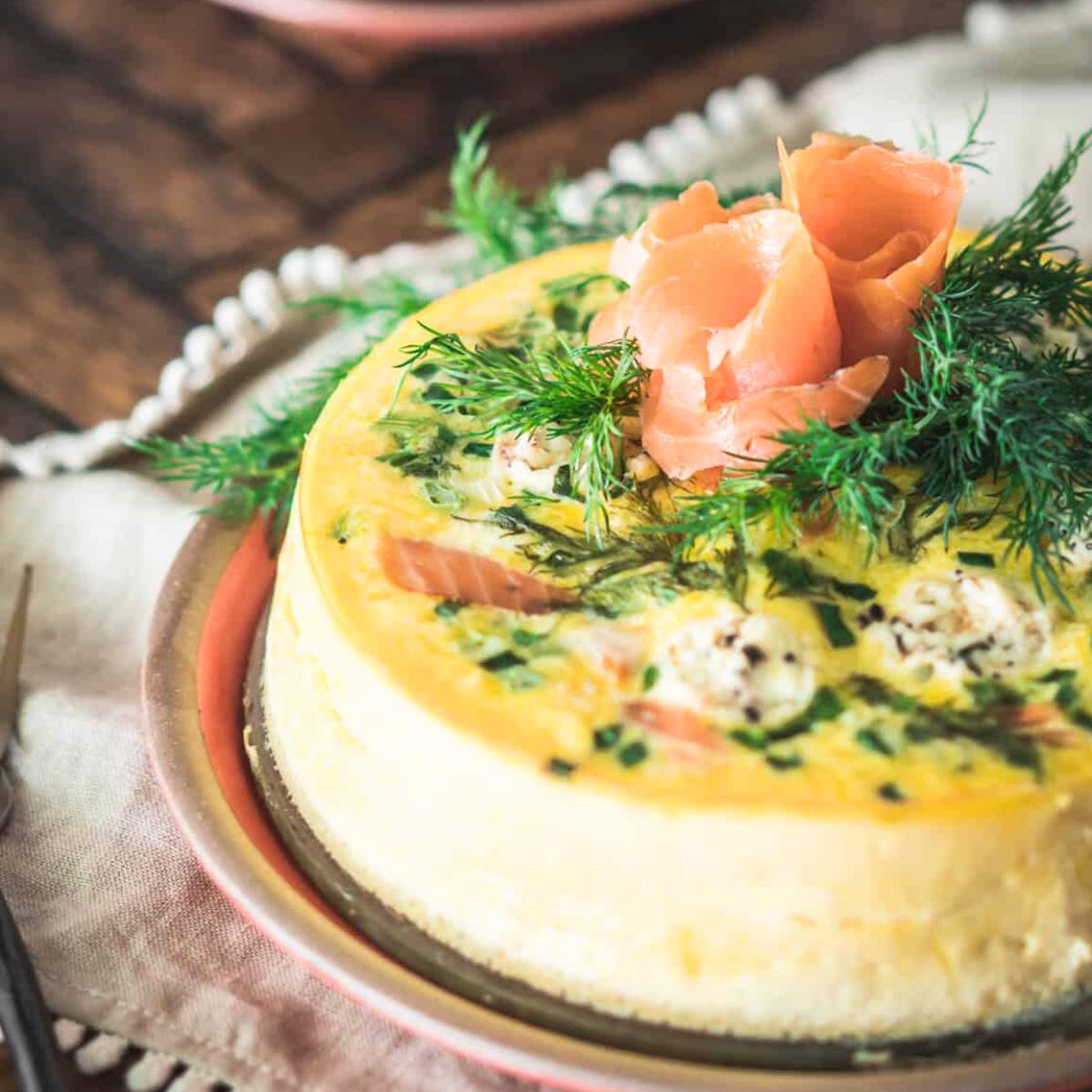 A fluffy Instant Pot Smoked Salmon Frittata, packed with tender smoked salmon, eggs, and fresh herbs, served in slices for a flavorful and protein-rich breakfast.