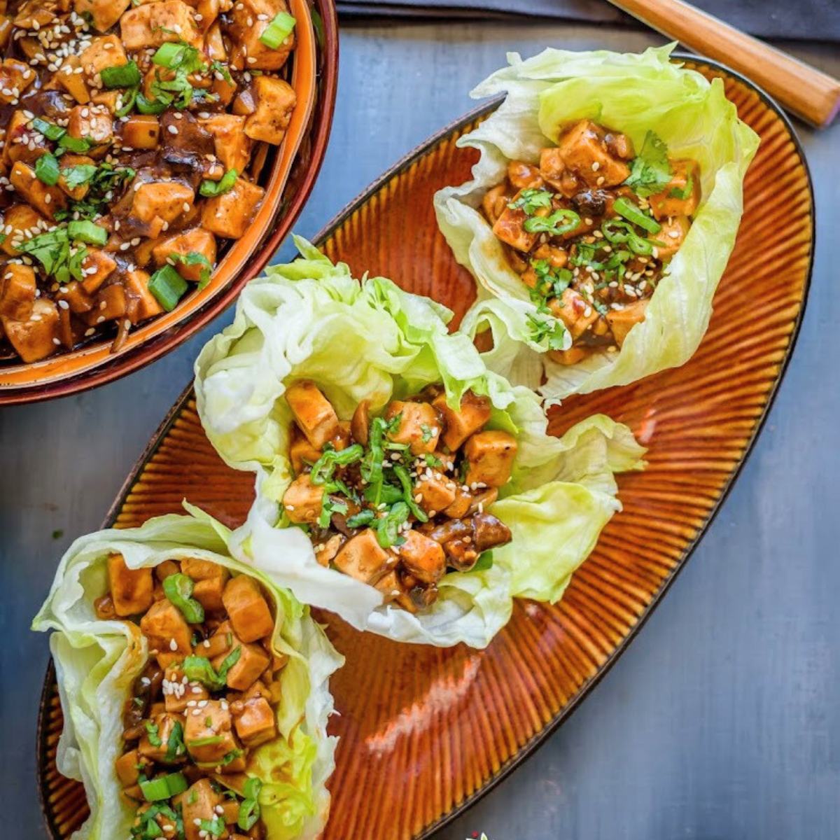 A delicious Instant Pot Vegan Tofu Lettuce Wraps with crispy tofu, sautéed veggies, and a savory soy-ginger sauce, wrapped in fresh lettuce leaves.








