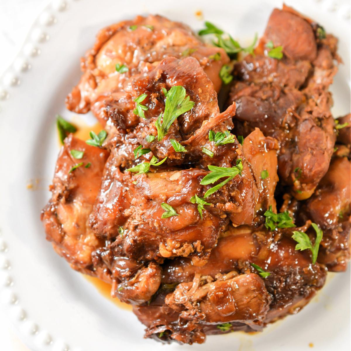 Flavorful Keto Instant Pot Chicken Adobo, simmered in a tangy, savory soy-vinegar sauce with garlic and spices, served with a low-carb side for a satisfying meal.