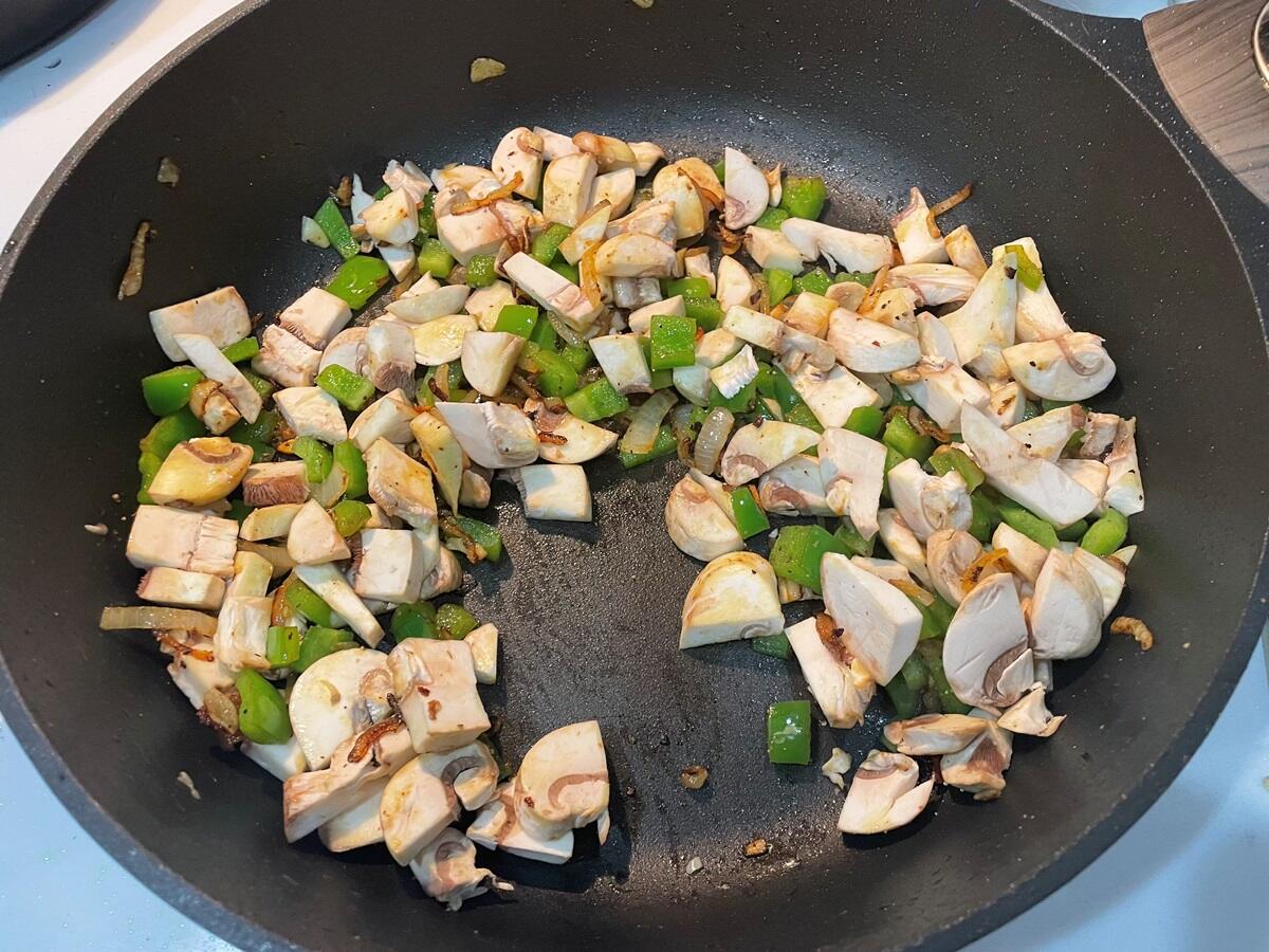 green peppers, onion, mushrooms, and garlic in a pan