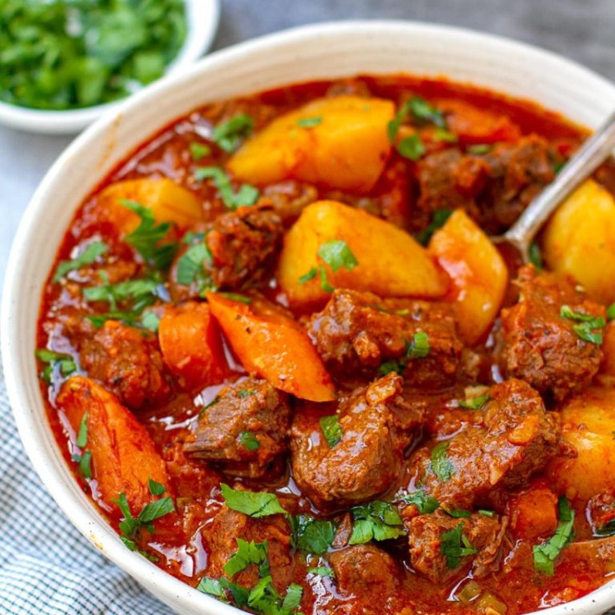 A hearty Whole30 Beef Stew with tender beef, carrots, potatoes, and celery, simmered in a rich, savory broth with herbs and spices.