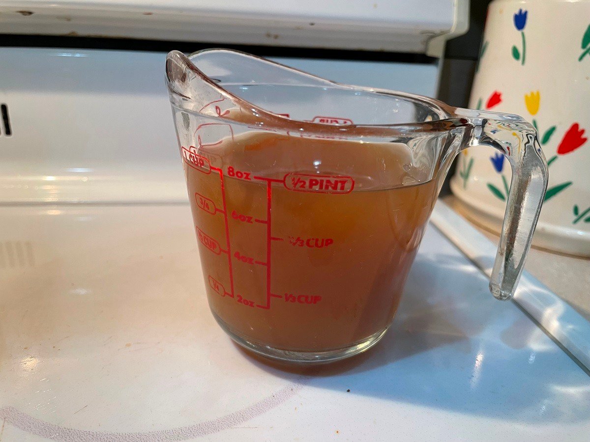 beef bone broth in a glass measuring cup