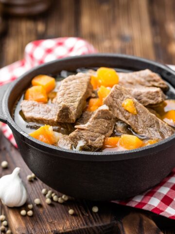 delicious braised beef meat in broth with vegetables, goulash