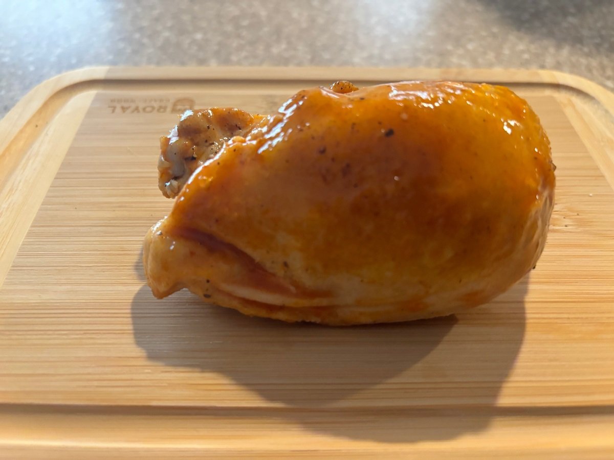 cooked chicken meat on a wooden chopping board