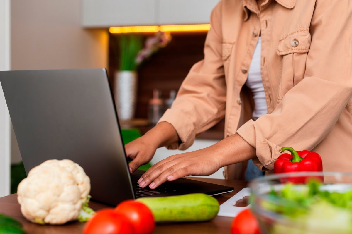 woman working on laptop in kitchen