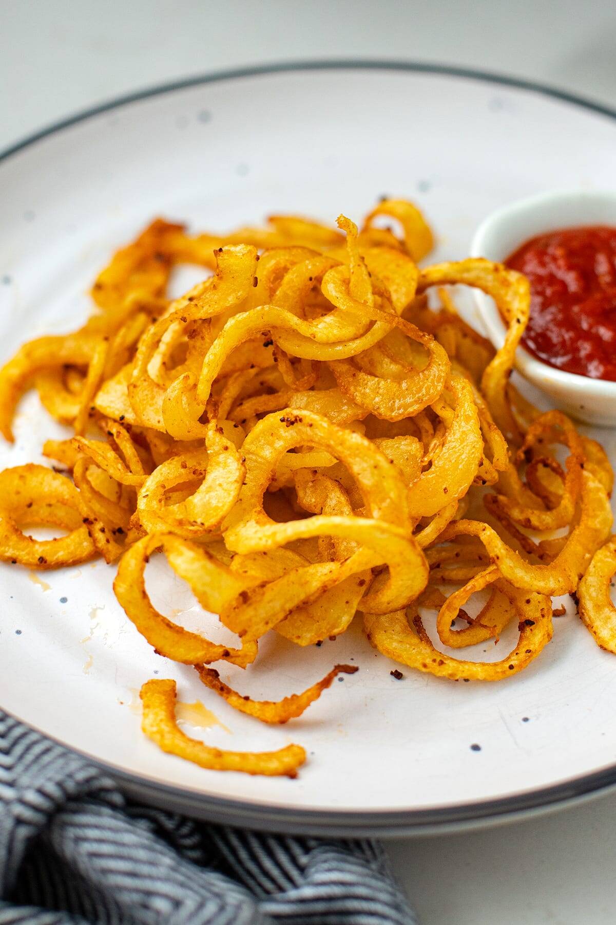 air fryer curly fries on the white plate