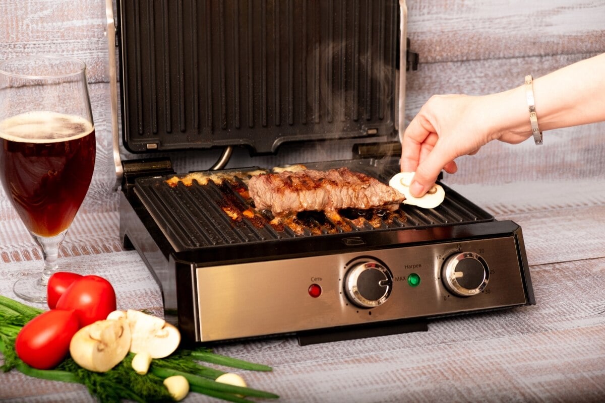 beef steak with vegetables on electric grill