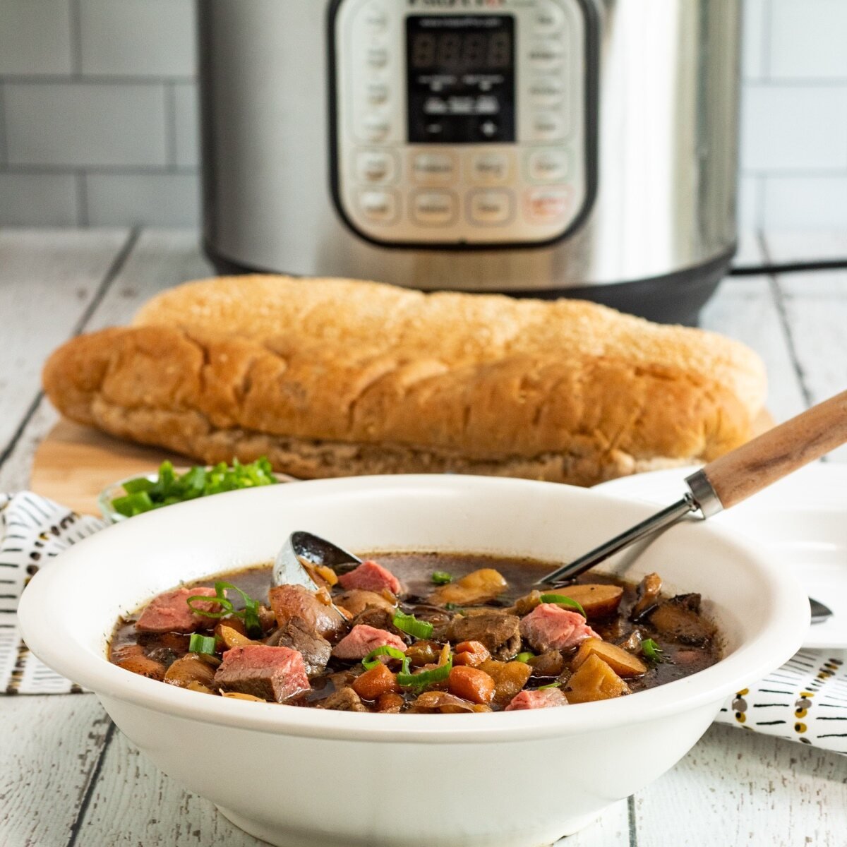 stew, bread and instant pot on kitchen counter