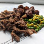 sticky pulled pork with potato, green peas and sweet corns